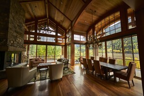A spacious room with a large dining table, comfortable seating, and large windows offering scenic views. - Family, Friends and Festivals! Enjoy Telluride at its Finest! (Telluride)