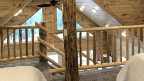 A high-ceilinged room with a wooden ceiling, a central wooden pillar, a ceiling fan, and a view of the outdoors through a window. - 8 miles to Mount Rushmore - Sleeps 2 to 6 (Rapid City)