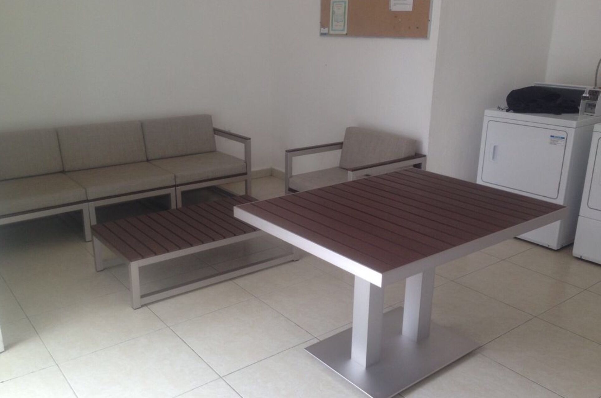 A room with a sofa, a table, and a cabinet.