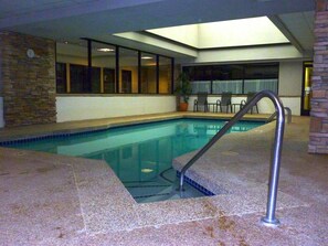 Swimmers can enjoy a refreshing dip in the rectangular pool surrounded by a deck.