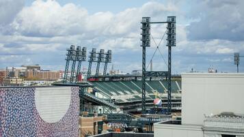 A stadium with multiple tiers of seating, a large scoreboard, and a prominent entrance gate.