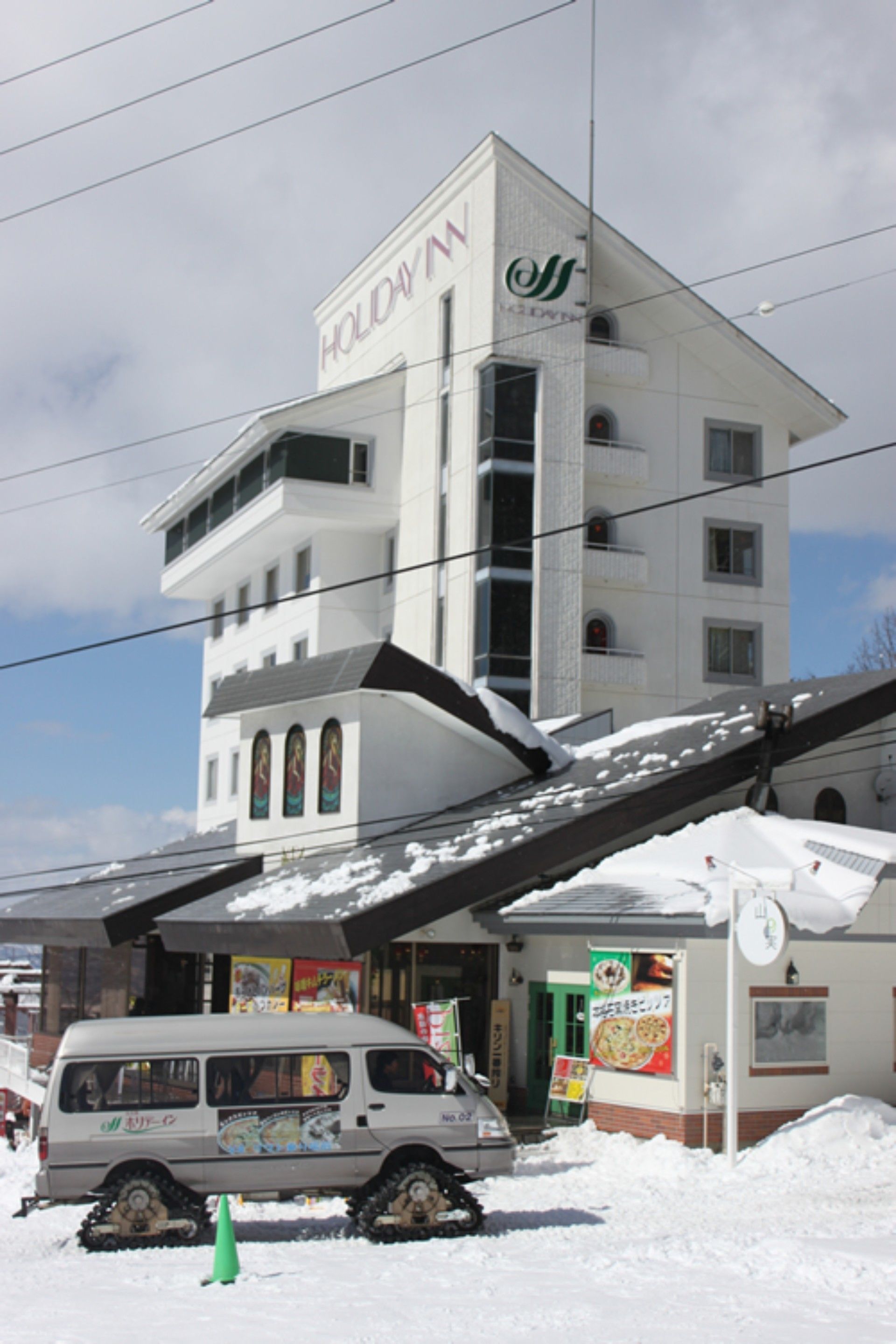 A multi-story building with a sign reading "HOLIDAY N".
