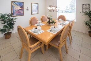 A dining room with a wooden table set for four, surrounded by cushioned chairs. - Ip60344 - Windsor Hills Resort - 5 Bed 5 Baths Villa (Kissimmee)