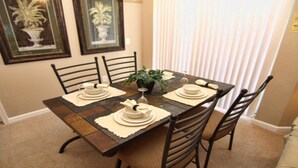A dining table set with plates, glasses, and a centerpiece. - Tr422 - Terrace Ridge - 2 Bed 2 Baths Condo (Davenport)