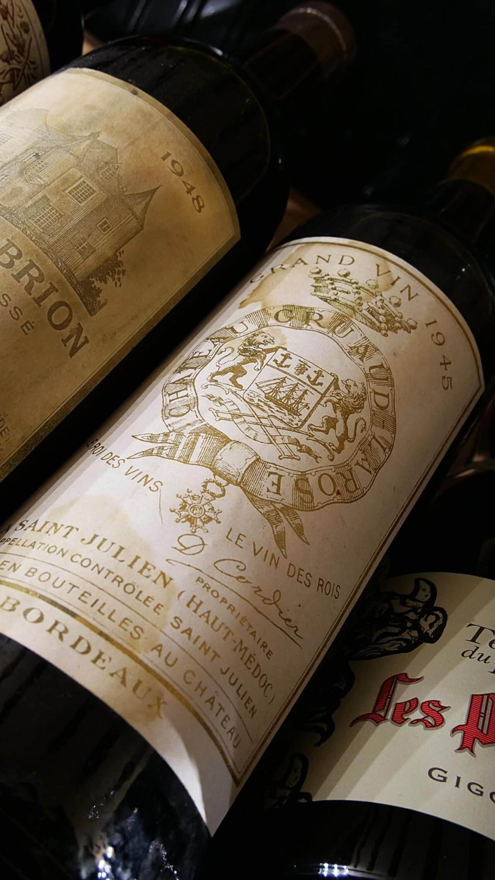 A close-up of wine bottle labels with vintage and branding details.