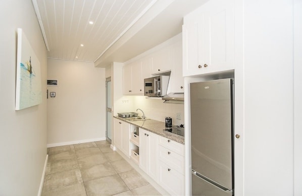 Apartment, Non Smoking | Private kitchen | Full-size fridge, microwave, stovetop, electric kettle