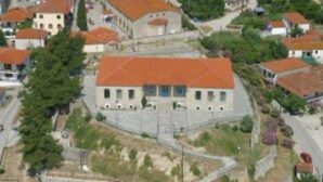 A building with a red-tiled roof, surrounded by smaller buildings and greenery. - Maisonette Maria - for tranquility. Sykia Chalkidikis (Sithonia)