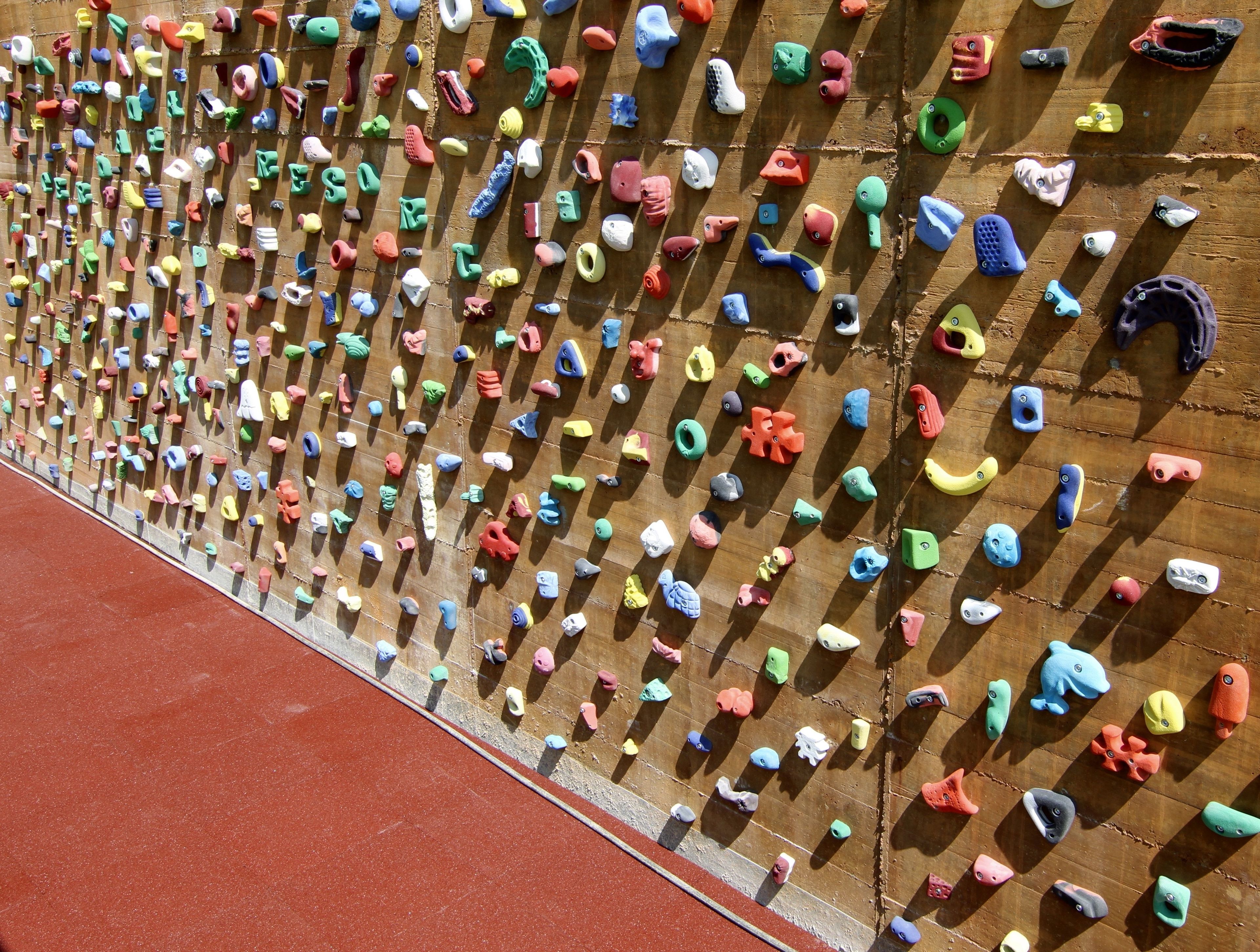 A climbing wall with various handholds and footholds.