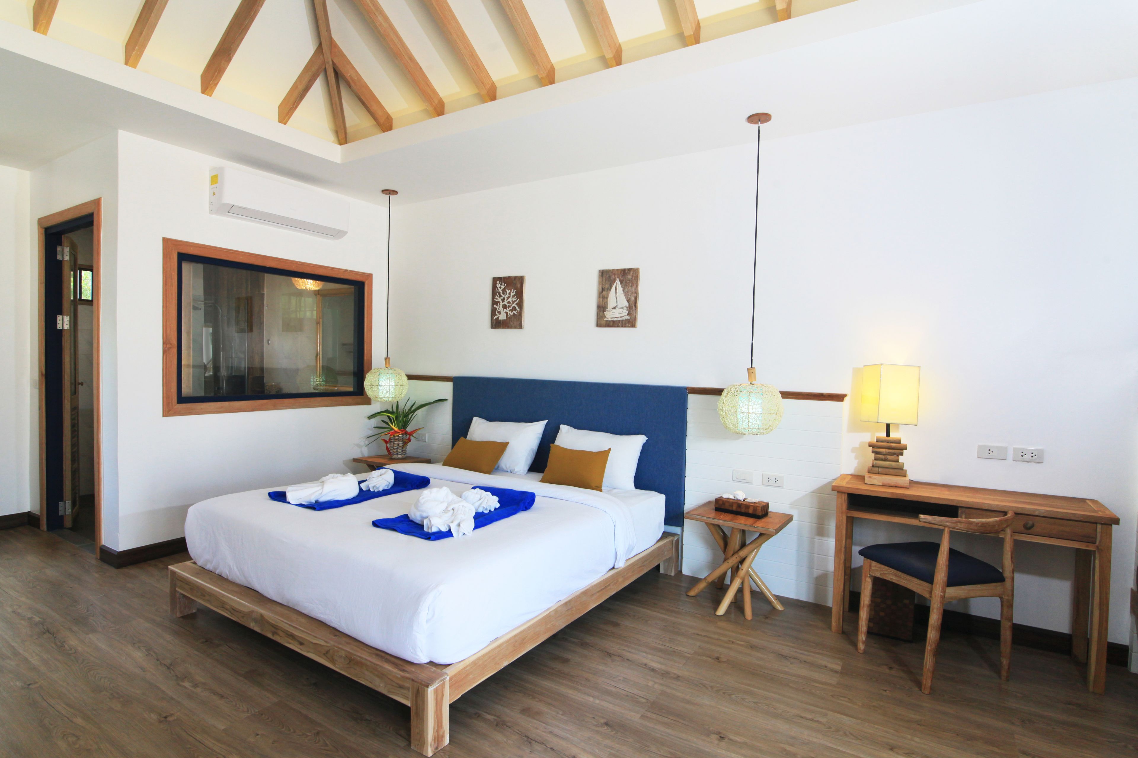 A bedroom with a wooden bed, a desk, and a chair.