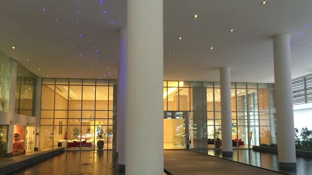 A spacious indoor area with a reflective floor, large glass windows, and a modern architectural design. - Marc B20-09 by SYNC (Kuala Lumpur)