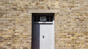 A brick wall with a door labeled "287". - Caledonian Studio Flats (London)