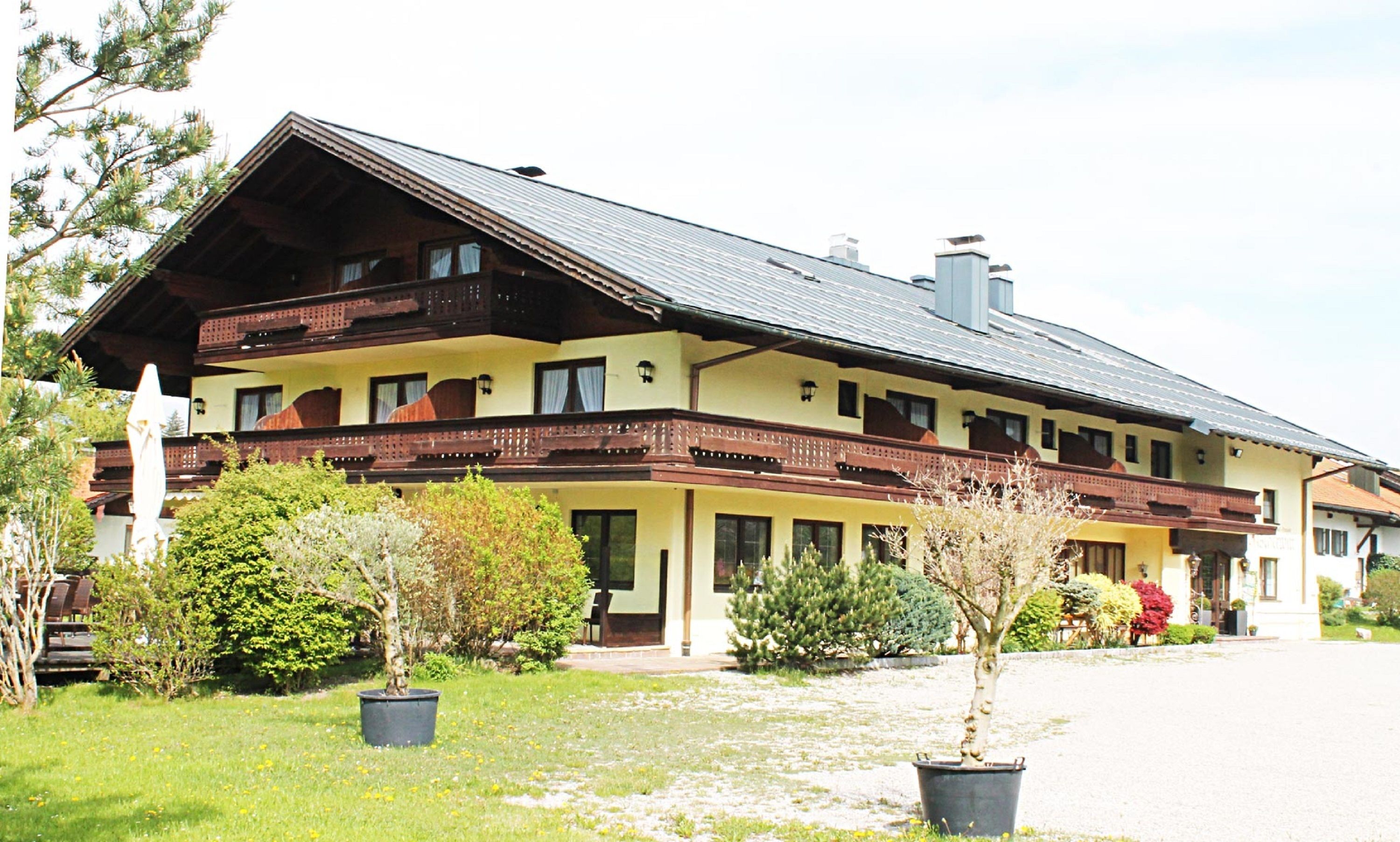 A two-story building with a sloped roof and wooden balconies.