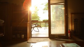 A room with a sliding glass door leading to an outdoor deck.