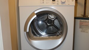 A stacked Bosch washing machine and dryer unit in a laundry room. - Great Mountain Get Away (Boone)