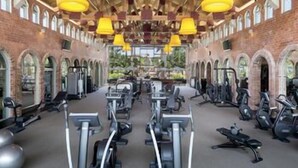 A gym with exercise equipment, brick walls, and arched windows. - Dorado Beach a Ritz Carlton Reserve (Dorado)