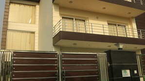A multi-story residential building with a gated entrance, balconies, and a flat roof. - Treehouse Neo Casa-Unit of Neo Residency (Gurugram)