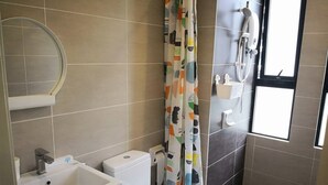 A bathroom with a toilet, sink, and shower. - ETM Midhills Holiday Studio (Genting Highlands)