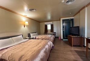 A hotel room with two beds, a television, a desk, and a window with curtains. - San Ho Business Hotel (Xiluo)