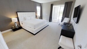 A modern hotel room with a large bed, a desk with a chair, a TV, and a window with curtains.