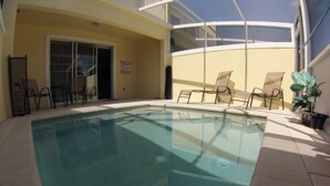 An indoor swimming pool with clear water, surrounded by beige walls and a glass enclosure. - Aco63664 - Serenity - 3 Bed 3 Baths Townhouse (Clermont)