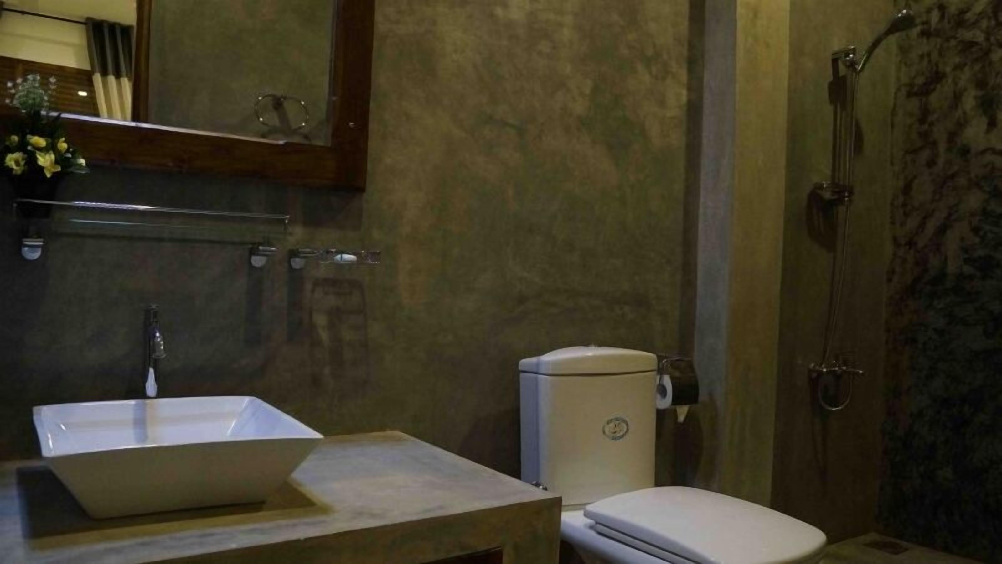 A bathroom with a sink, toilet, and shower.