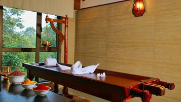 Enjoy a warm and inviting space with a traditional table set amidst lush greenery views.