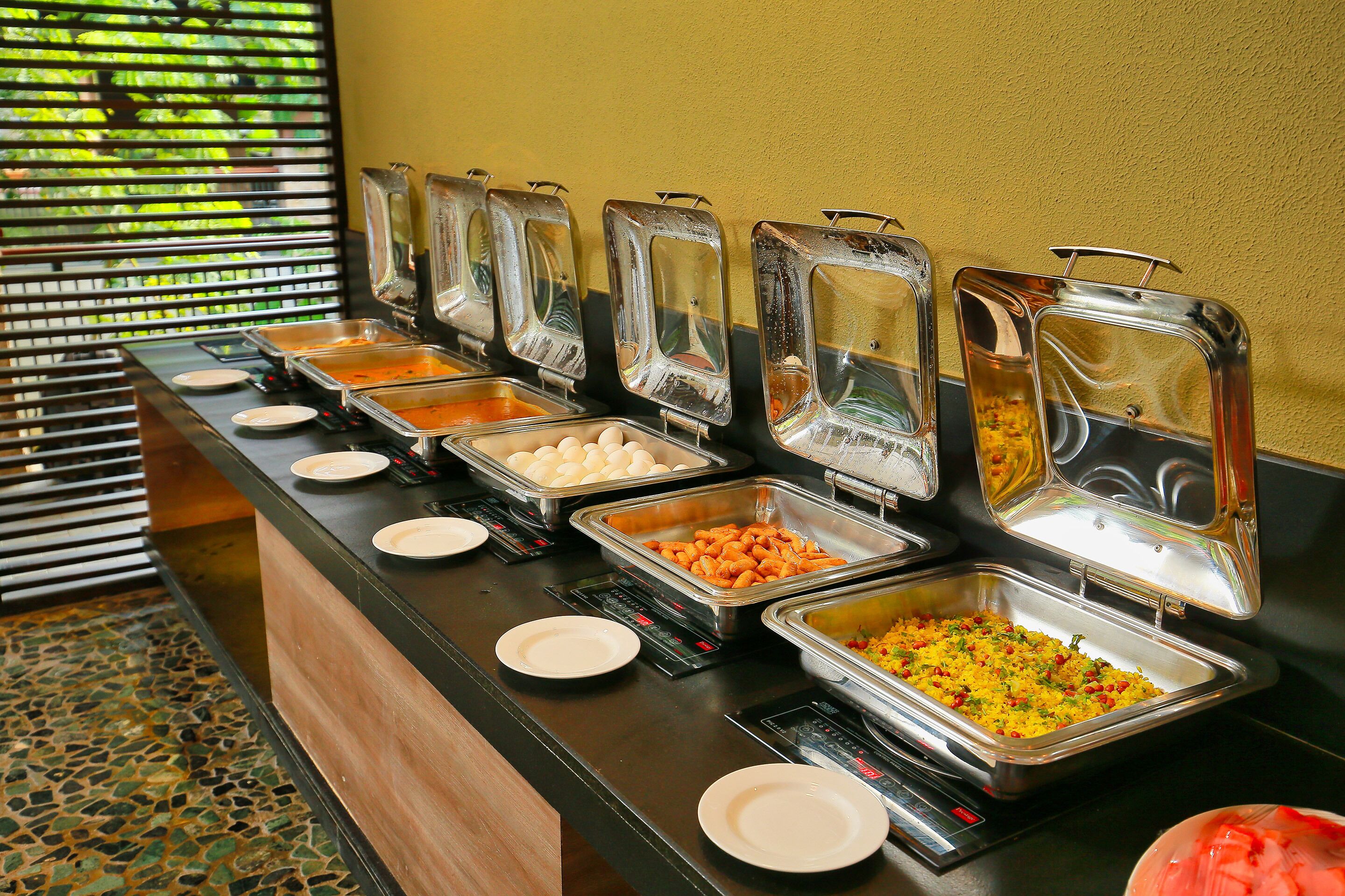 A buffet with various food items in clear containers.