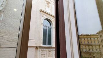 A building facade with a large arched window and detailed architectural carvings.