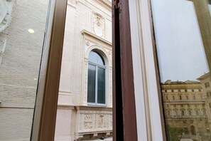 A building facade with a large arched window and detailed architectural carvings.