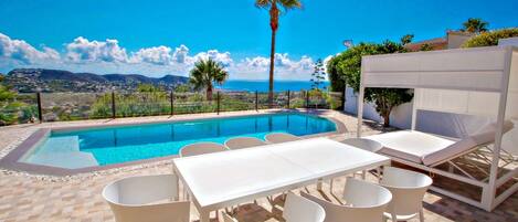 A heated pool, sun loungers