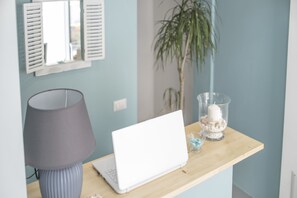 Work in comfort with a desk, lamp, and ample space.