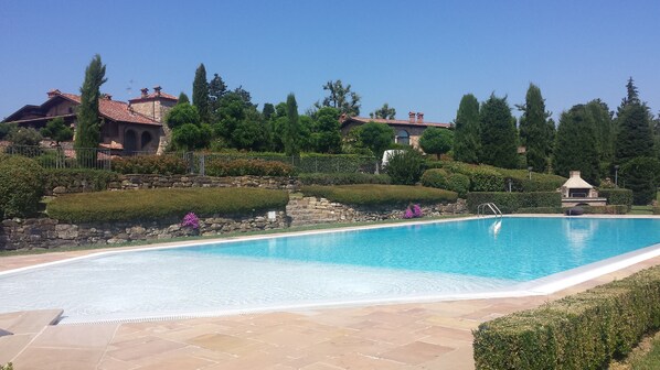 Een seizoensgebonden buitenzwembad en parasols bij het zwembad