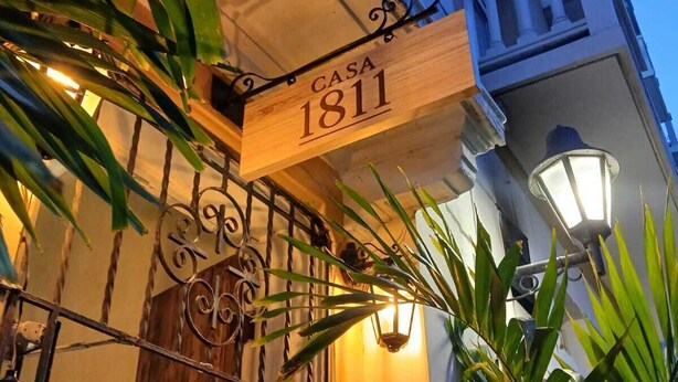 A building with a sign reading "CASA 1811" and a wrought iron gate. - Casa 1811 (Cartagena)