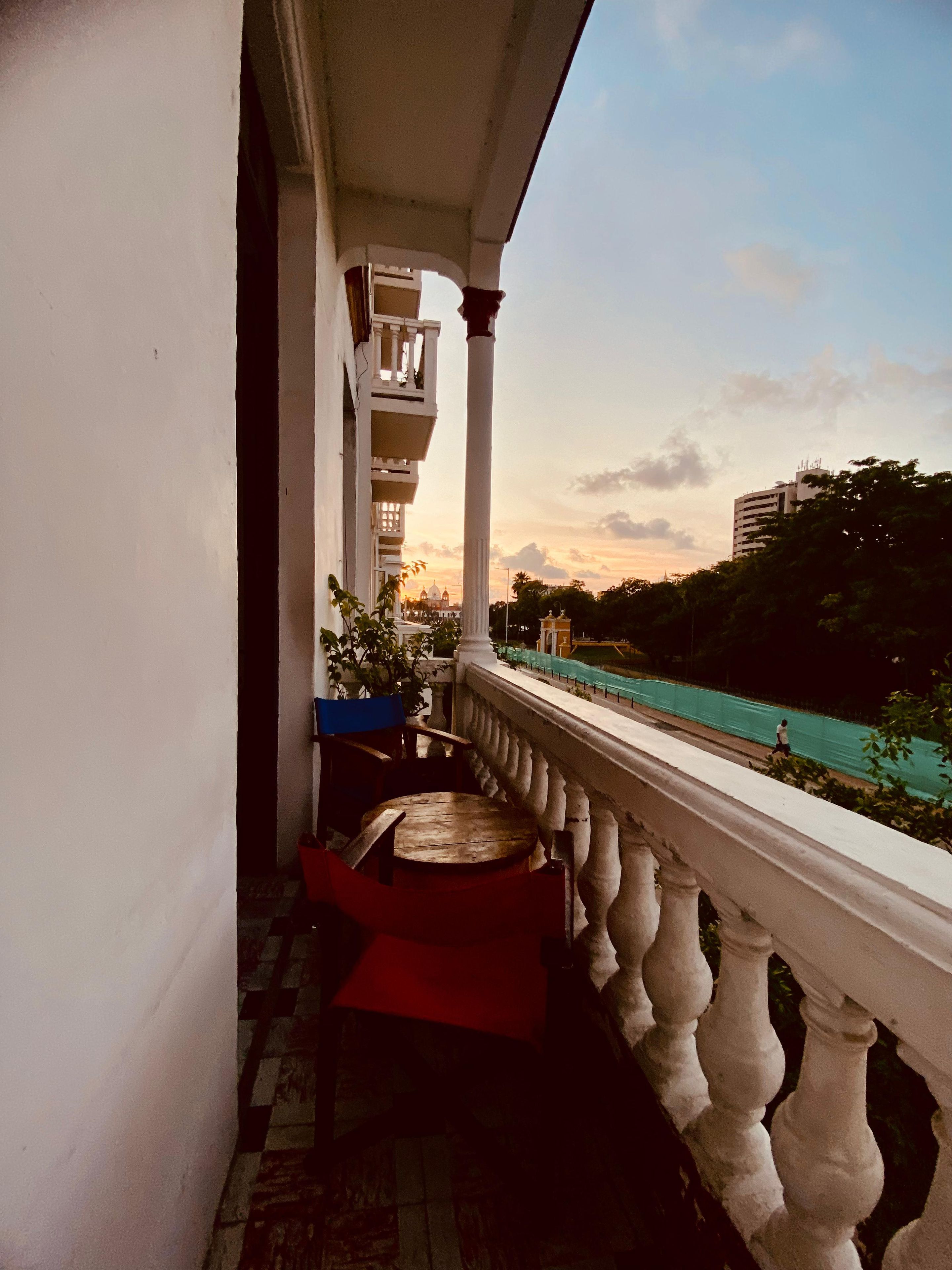 A balcony with a view of a building and a river.