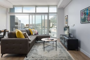 Deluxe Apartment | Living room | Flat-screen TV