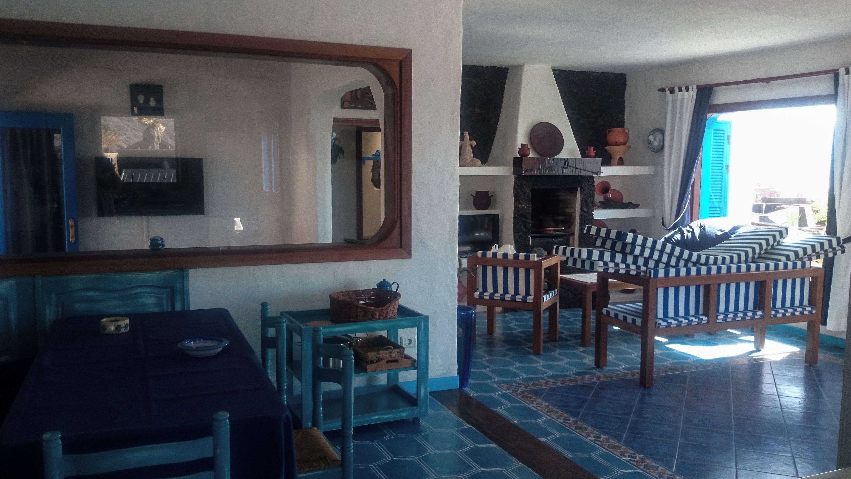 A living room with a sofa set, a television, and a fireplace.