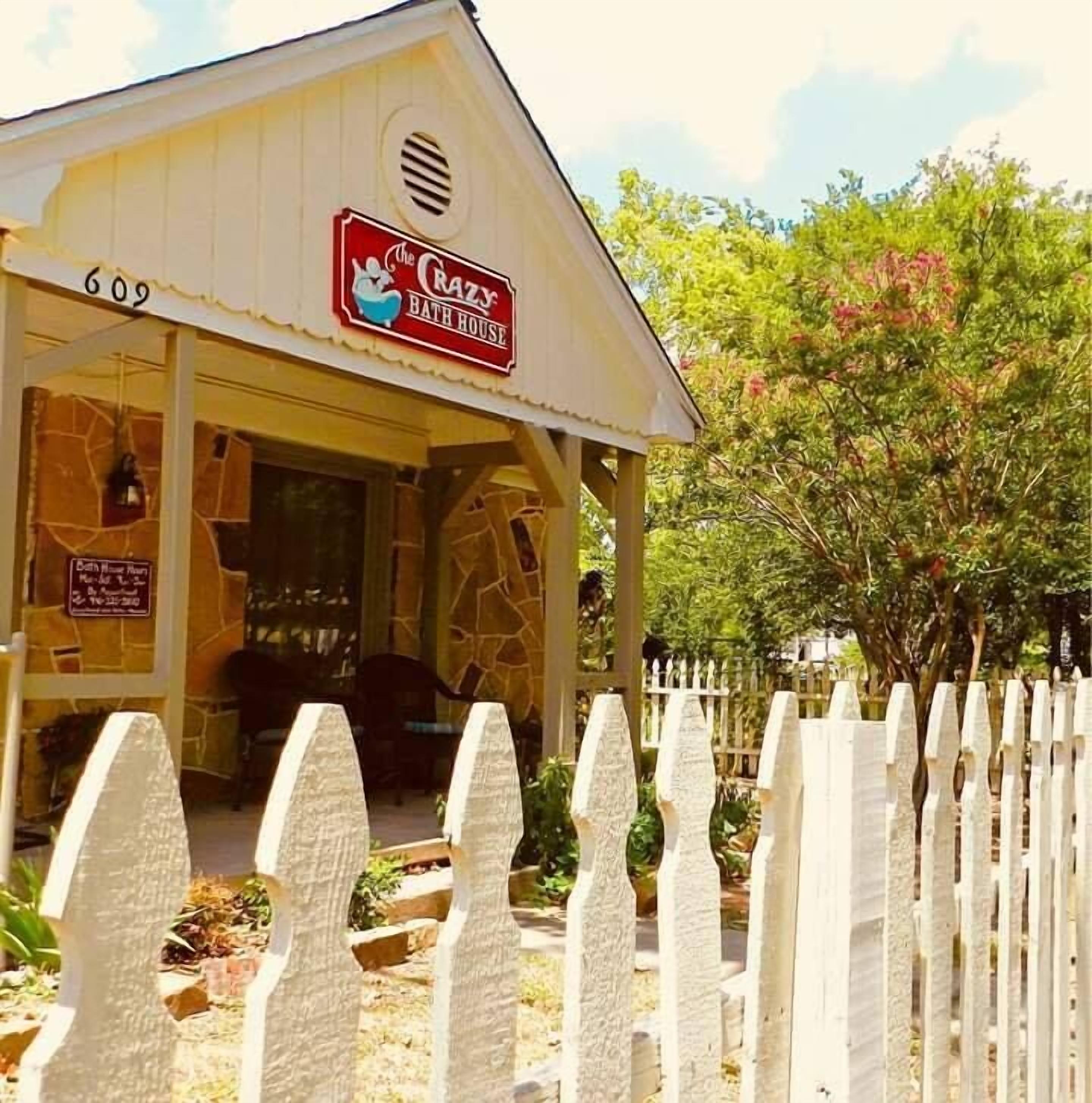 A white building with a sign reading "The Crazy Bath House" and a number "609" on the side.