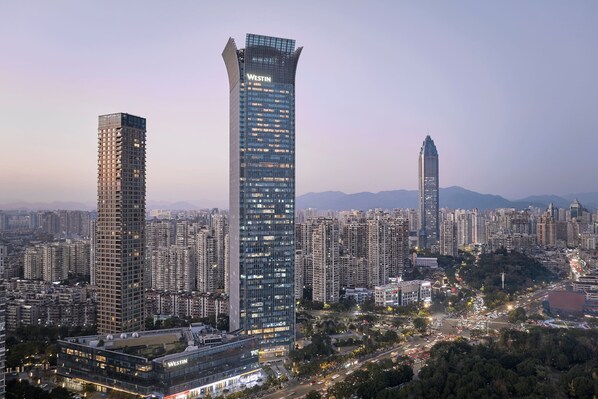 A high-rise building with the name "WESTIN" prominently displayed, surrounded by a dense urban environment with other tall buildings and a network of roads. - The Westin Wenzhou (Wenzhou)