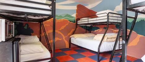 A bunk bed room with a checkered floor and a mural on the wall.
