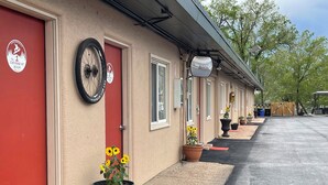 A row of rooms with red doors, each marked with a number. - RAD Hostel (Colorado Springs)