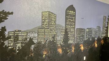 A cityscape mural with buildings and trees.