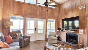A living room with a fireplace, television, and seating area.