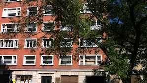 A multi-story building with a brick facade, several windows, and a ground-level entrance. - Apartment TOU T CONFORT, in the HEART of Old Lille, Balconnet (Lille)