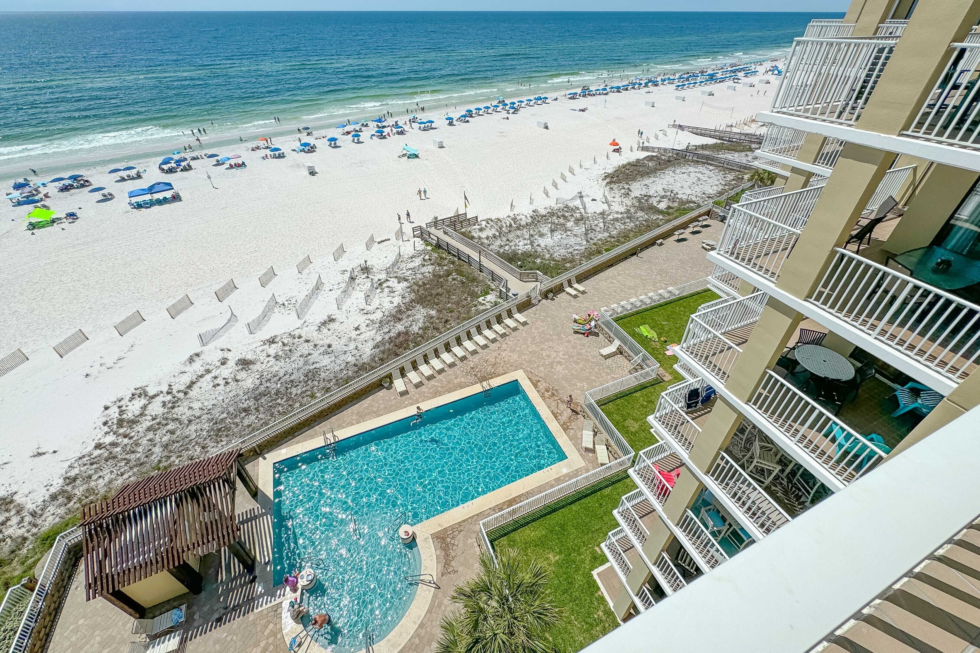 A hotel with a pool, beach access, and balconies.