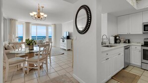 A modern kitchen with white cabinets, a microwave, and a coffee maker. - St. Croix  #805, Awesome View From Every Room! (Destin)