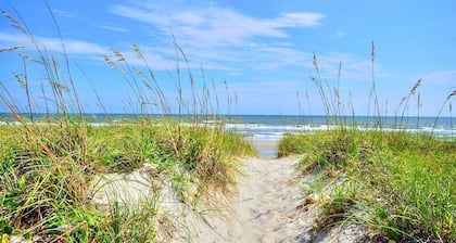 Oceanview retreat in Oak Island, 3BR condo with pool access and family amenities.