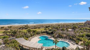 A resort with a large pool, beach view, and tropical landscaping. - Oceanfront 3br/3ba Shipwatch Villa, Oceanfront (Fernandina Beach)