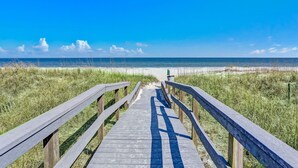 A wooden boardwalk leading to a beach with a clear blue sky. - Oceanfront 3br/3ba Shipwatch Villa, Oceanfront (Fernandina Beach)