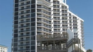 A high-rise hotel with multiple balconies, a beachside location, and a pool area. - Sunshine Daydream-Panoramic Gulf Views from Every Room! Beach Chair Svc Included (Miramar Beach)