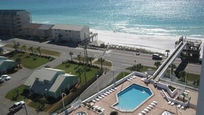 A hotel with a pool, beach view, and a parking lot. - Sunshine Daydream-Panoramic Gulf Views from Every Room! Beach Chair Svc Included (Miramar Beach)
